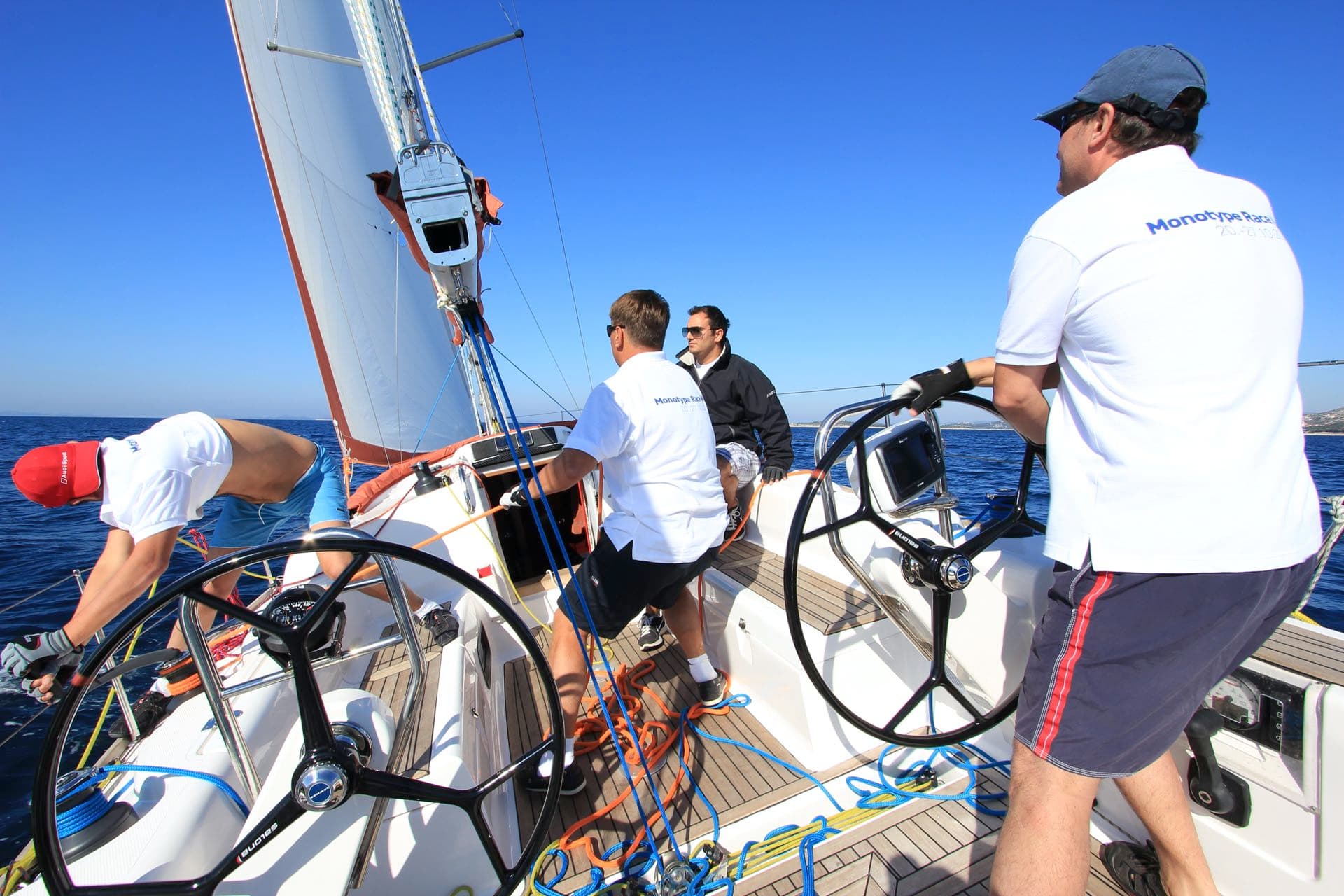 Four men handling a boat and sailing